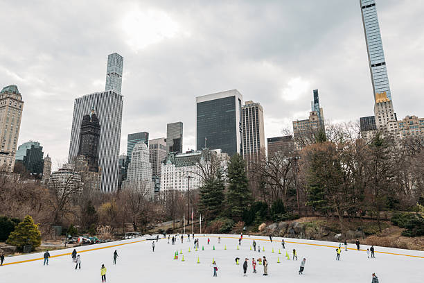 istock Skaters Enjoying Ice Rink in Urban Park 2207171531