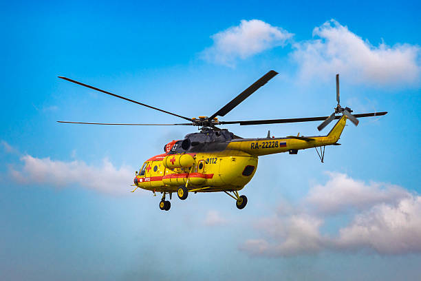Krasnoyarsk, Russia - 2 September, 2023: Yellow medical helicopter at blue sky. Emergency medical service team.