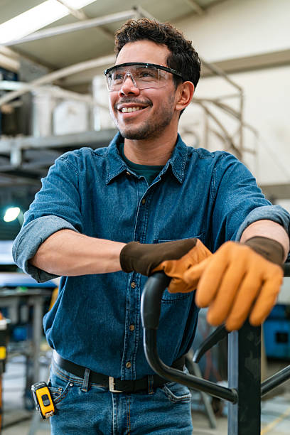 istock Happy factory employee using a pallet jack to move merchandise 2207176956