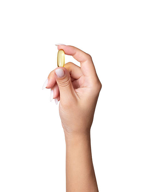 istock Female hand holding omega 3 capsule 2207181261