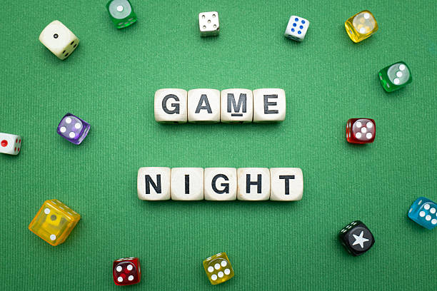 istock 'Game Night' word dice on green baize fabric. 2207186020