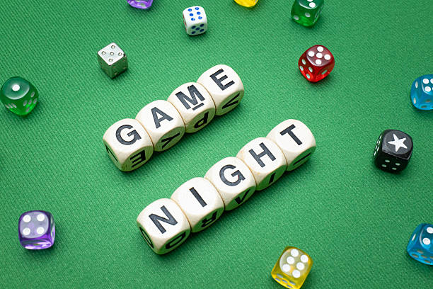 istock 'Game Night' word dice on green baize fabric. 2207186023