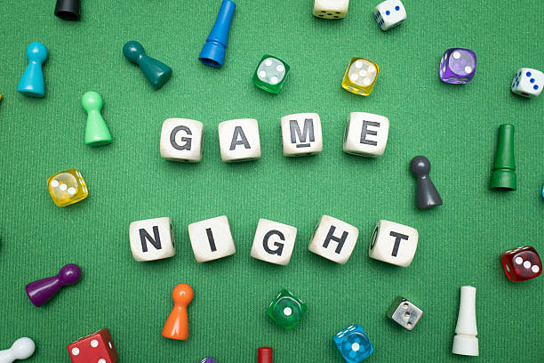 istock 'Game Night' word dice on green baize fabric. 2207186123