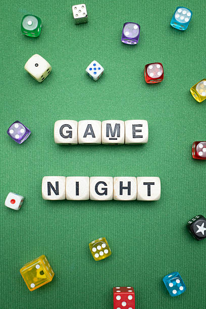 istock 'Game Night' word dice on green baize fabric. 2207186139