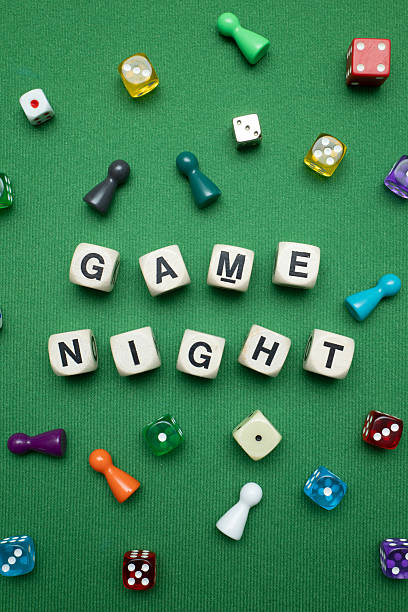 istock 'Game Night' word dice on green baize fabric. 2207186206