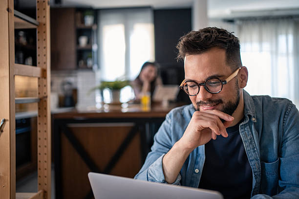 istock Focused freelancer working from home on laptop in kitchen 2207187525