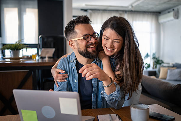 istock Young couple sharing a happy moment while working from home 2207187554