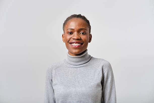 istock Young smiling black woman with braided hair posing in studio 2207188749