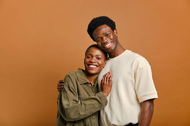 istock Happy young couple embracing and smiling at camera 2207188906