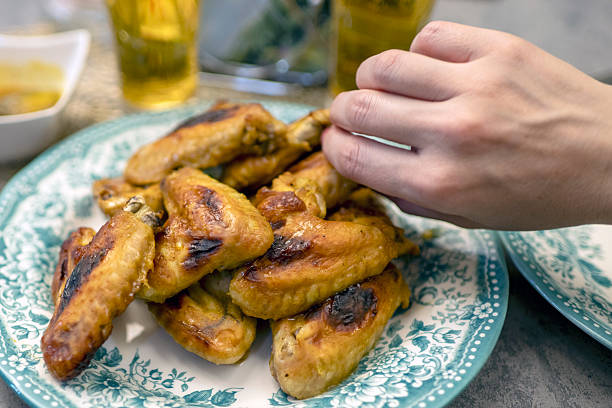 Salt-grilled chicken wings on white plate