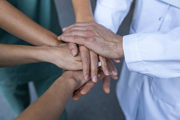 istock Top view of people hands clasping together tightly 2207190633