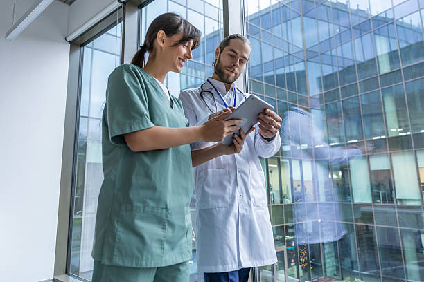 istock Two doctors discussing an interesting case while walking in the clinic corridor 2207190684