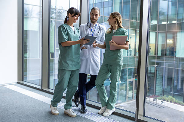 istock Team of young doctors discussing something and looking interested and involved 2207190695