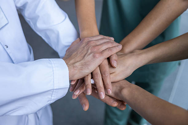 istock Top view of people hands clasping together tightly 2207190718