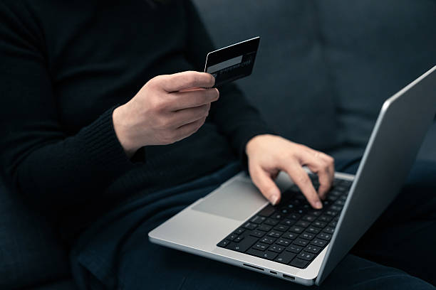 istock Woman uses digital card for secure online banking.  Modern financial technology, emphasizing ease and safety of remote transactions. Ideal for illustrating online banking, digital payments, or financial security. 2207192893