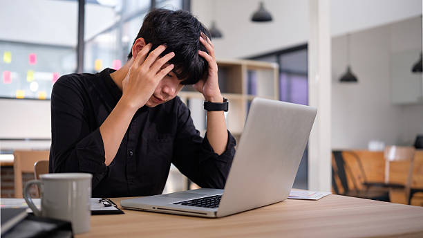 istock Stressed meal office worker experiences a moment of frustration while working on his laptop. 2207192947