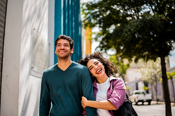 istock Young couple talking and walking outdoors 2207195385