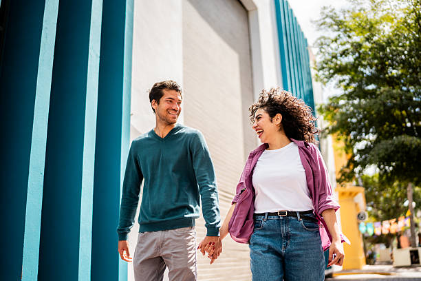 istock Young couple talking and walking outdoors 2207195428