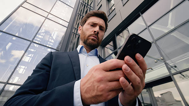 istock Mobile phone connection problem lost Wi-Fi broken smartphone entrepreneur near office angry upset with cellphone trouble online connect Caucasian man businessman guy male business in city bad signal 2207197673