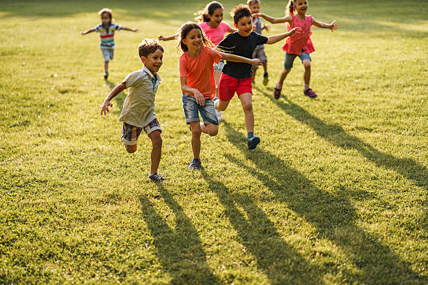 istock Joyful kids running on a meadow 2207198655