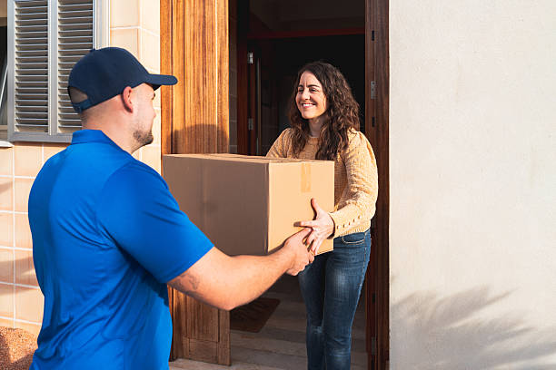 istock Customer Receiving Package from Courier at Home Entrance 2207198951
