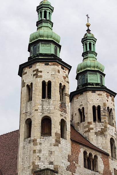 A medieval church with Romanesque stone towers and a green dome. A timeless architectural landmark