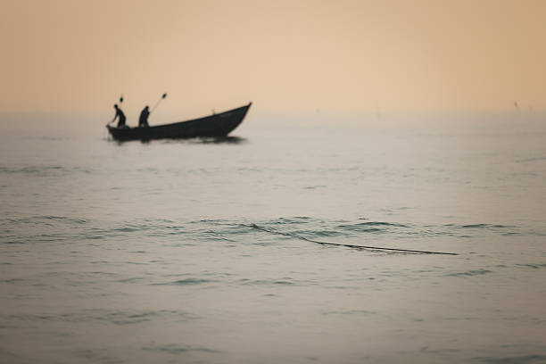 Fishermans are hunting a fish on fishing boat at sunrise.Da Nang - Vietnam.