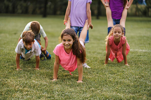 istock Children playing wheelbarrow race in public park 2207200592