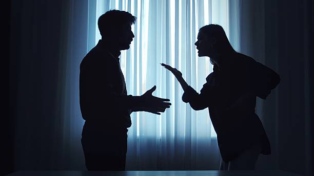 Silhouetted Couple in Intense Argument by Window Light