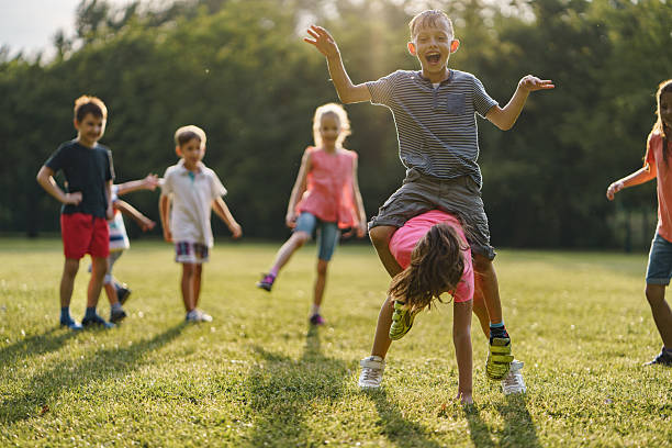 istock Children playing leapfrog game in public park 2207200838