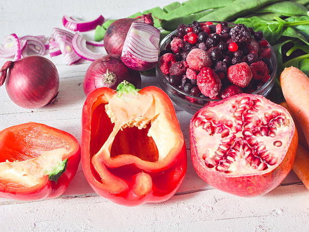 Multi colored vegetables and fruits on wooden table - vegetables and fruits in rainbow colors on rustic white wooden table - healthy eating, wellbeing, concepts & ideas