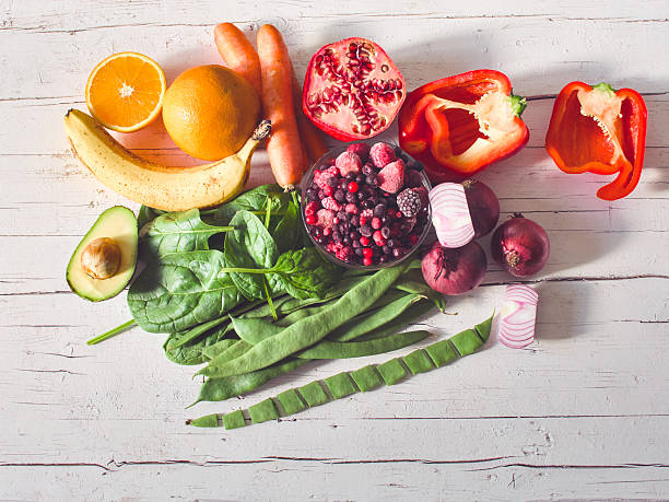 Multi colored vegetables and fruits on wooden table - vegetables and fruits in rainbow colors on rustic white wooden table - healthy eating, copy space, concepts & ideas