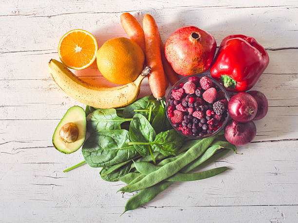 istock Multi colored vegetables and fruits on wooden table 2207201685