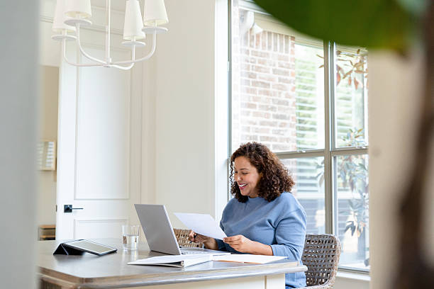 istock Smiling Woman Working from Home on Laptop 2207202069