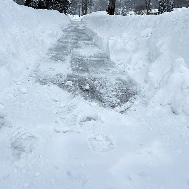 istock Freshly Cleaned Sidewalk With Snow Banks 2207202572