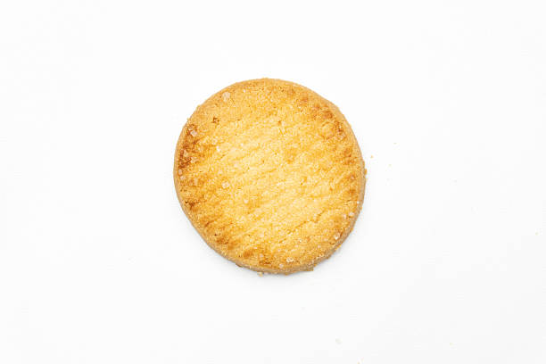 istock A single, round butter cookie is placed on a white background, highlighting its simple elegance and sugary coating. 2207203296