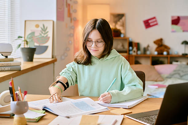 istock Woman Studying at Desk with Open Books and Papers 2207203895