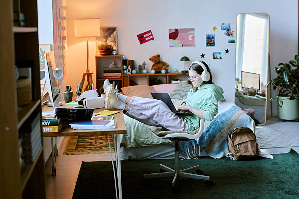 istock Studying in Cozy Bedroom Workspace with Headphones 2207205460
