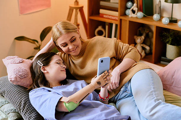 istock Young Women Taking Photo While Relaxing on Couch at Home 2207209070