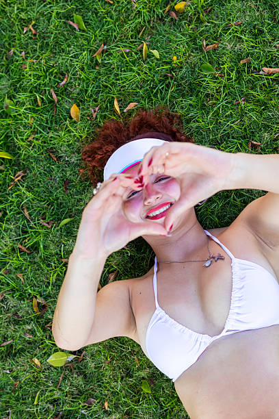 Young woman making a heart with her hands