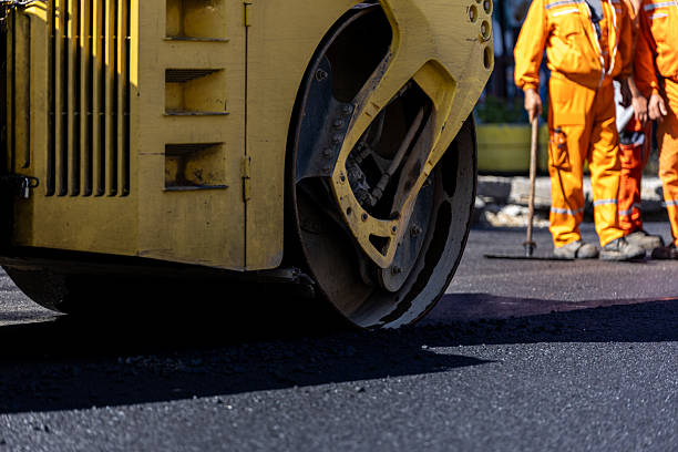 istock Road construction workers operating a heavy asphalt roller on a sunny day in an urban area 2207209845