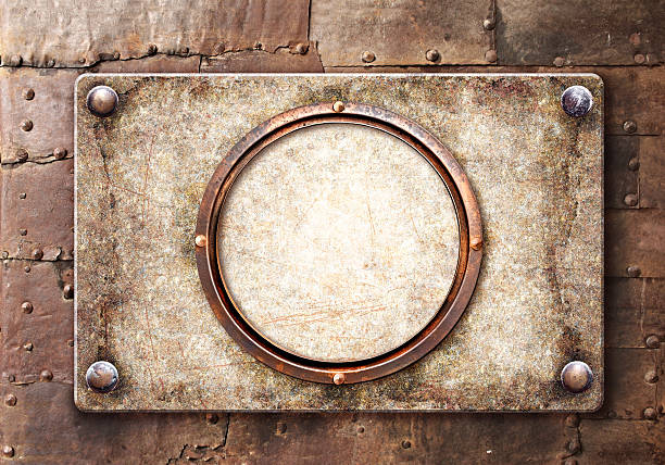 istock Old metallic plank with rivets and round frame. Vintage metal plate with nails. Can be used for steampunk, retro and vintage design. Mock up template. Copy space for text 2207210564