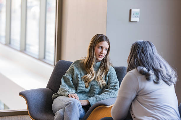 istock Young Woman in Counseling Session with Therapist 2207211233