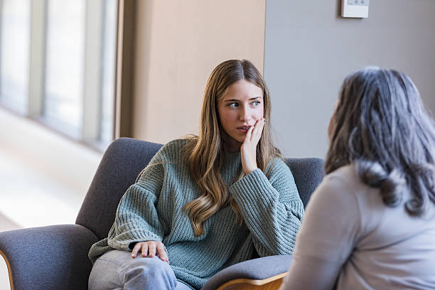 istock Young Woman Sharing Concerns During Counseling Session 2207211245