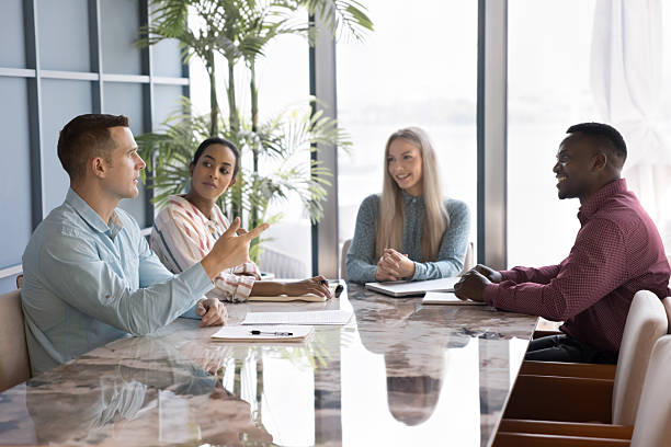 istock Serious successful business professional man explaining creative idea to colleagues 2207211323