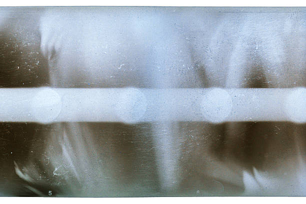 Close-up of a black dancer's face covered by his hands. Only his eyes look through the hands towards the viewer.