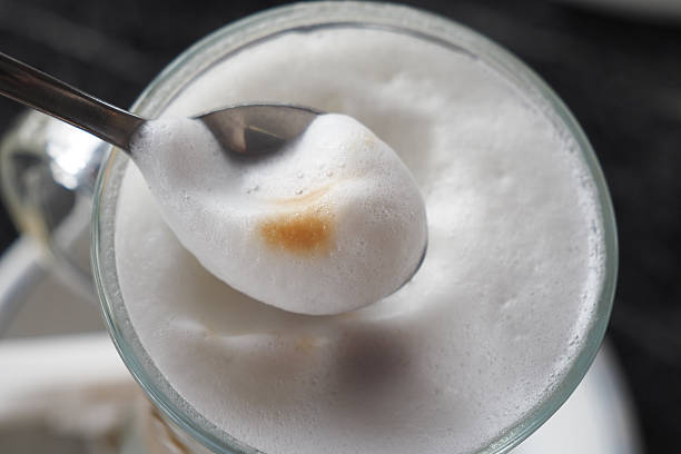 Rich and Creamy Foam on Coffee Served with a Spoon for Enjoyment