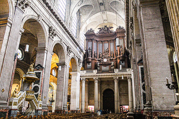 Image of the interior of the church of Saint Sulpice, with the amazing organ above the main door, in Paris, in March 2024