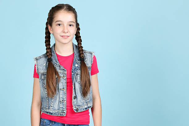 istock Beautiful young girl on blue background 2207213226