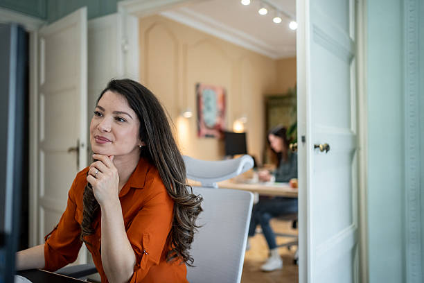 istock Young professional woman working in modern office 2207213302